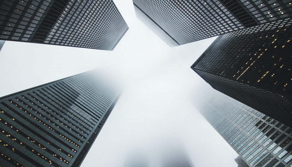 A black and white street view of skyscrapers.